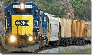 A photo of a CSX train roaring east on the Old Main Line after exiting Davis Tunnel.